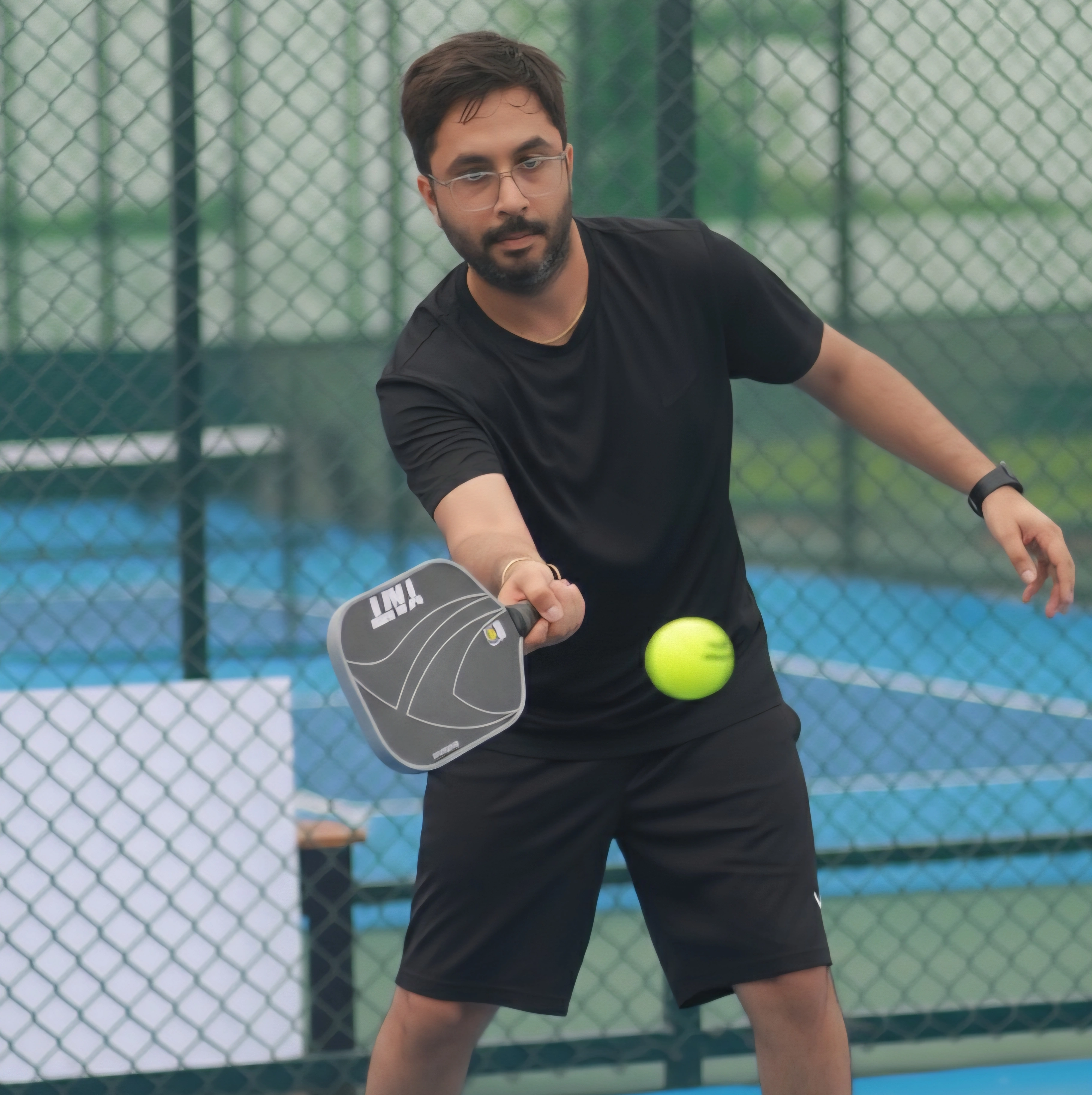 Founder playing pickleball on court