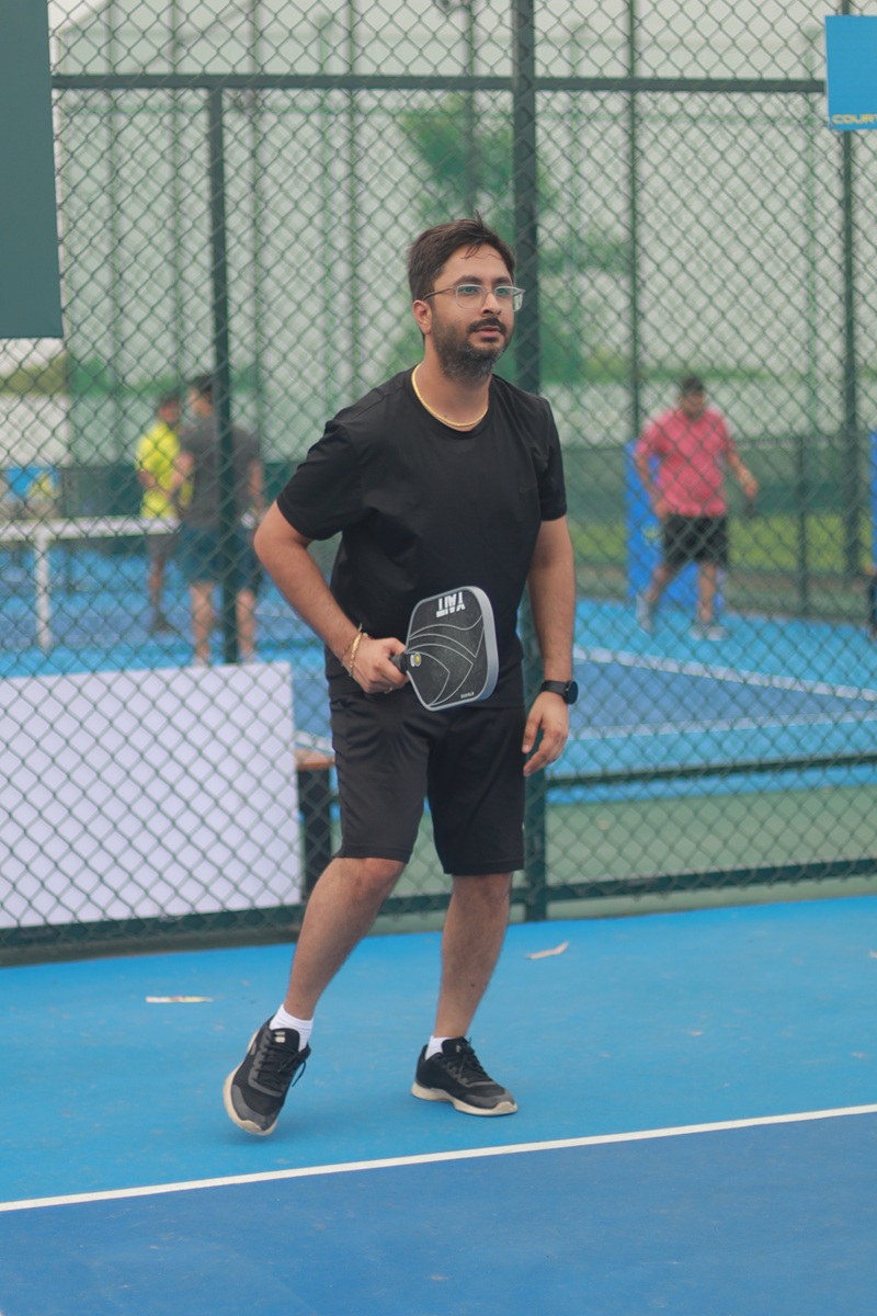 Founder playing pickleball on court